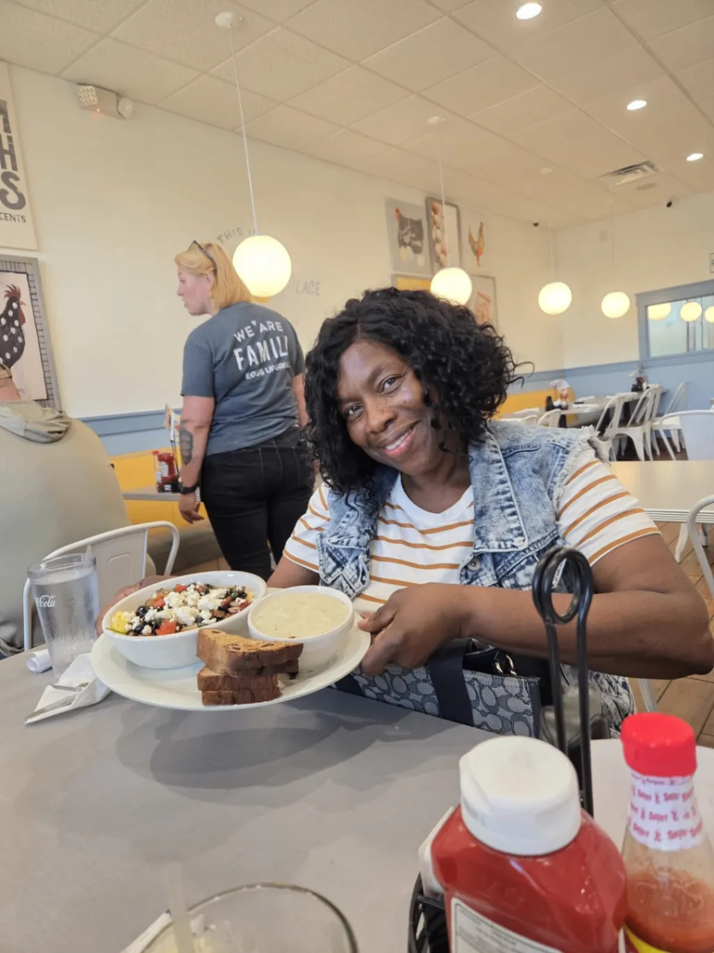 Team member smiling with her meal