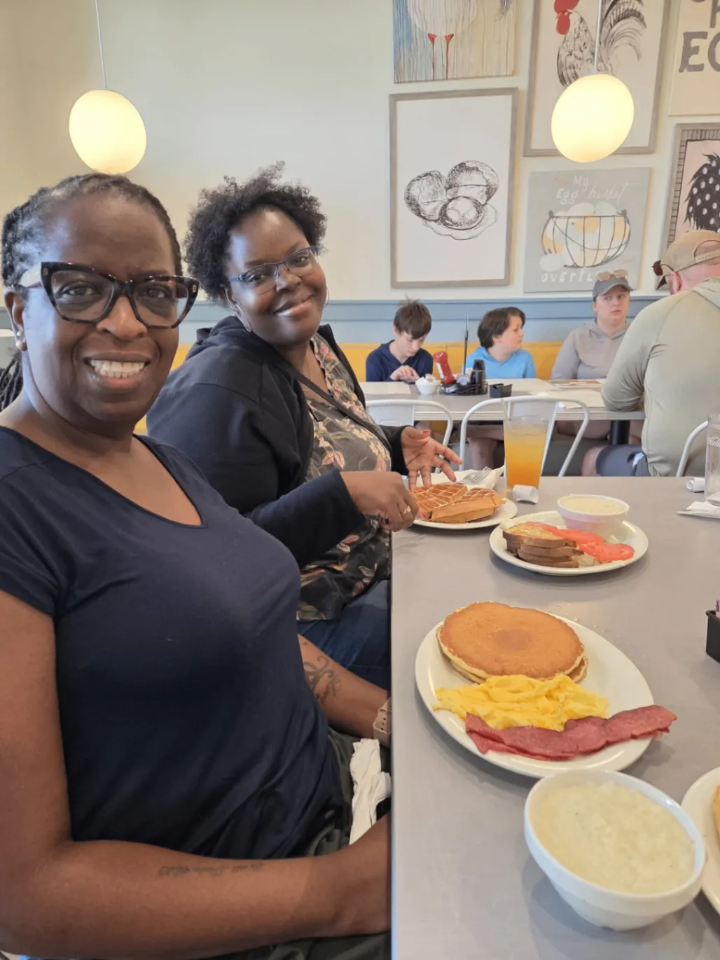 Two team members smiling together over a shared meal